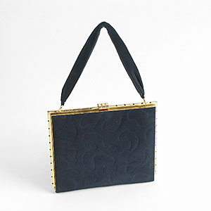  navy suede handbag with zigzag brass frame