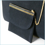 black suede handbag with an outer pocket