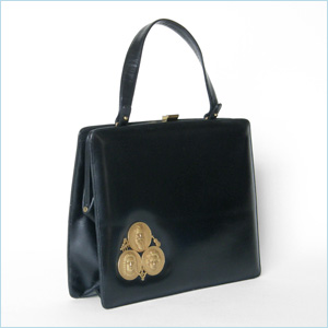 Trim, black leather handbag with classical music theme 