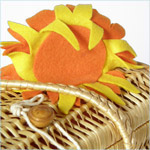 Fun, woven wicker box bag decorated with oversized felt sunglasses and su